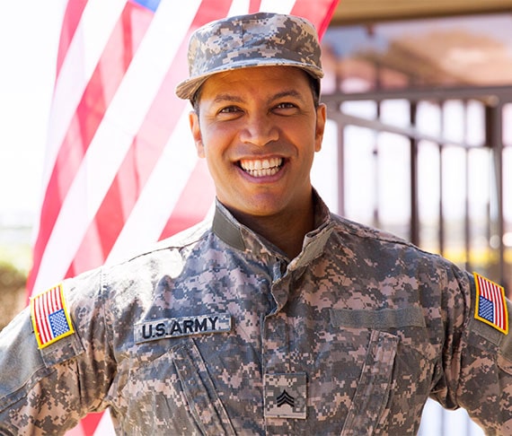 solider standing in front of flag